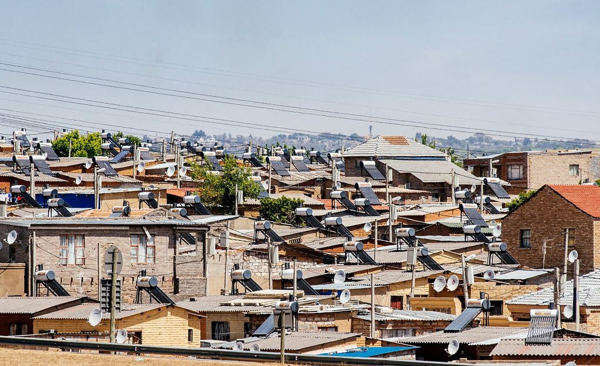 Rows of brick homes in Alexandra, solar water heaters and satellite dishes on almost every roof.